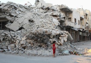 girl-stands-by-building-damaged-by-syrian-forces-data